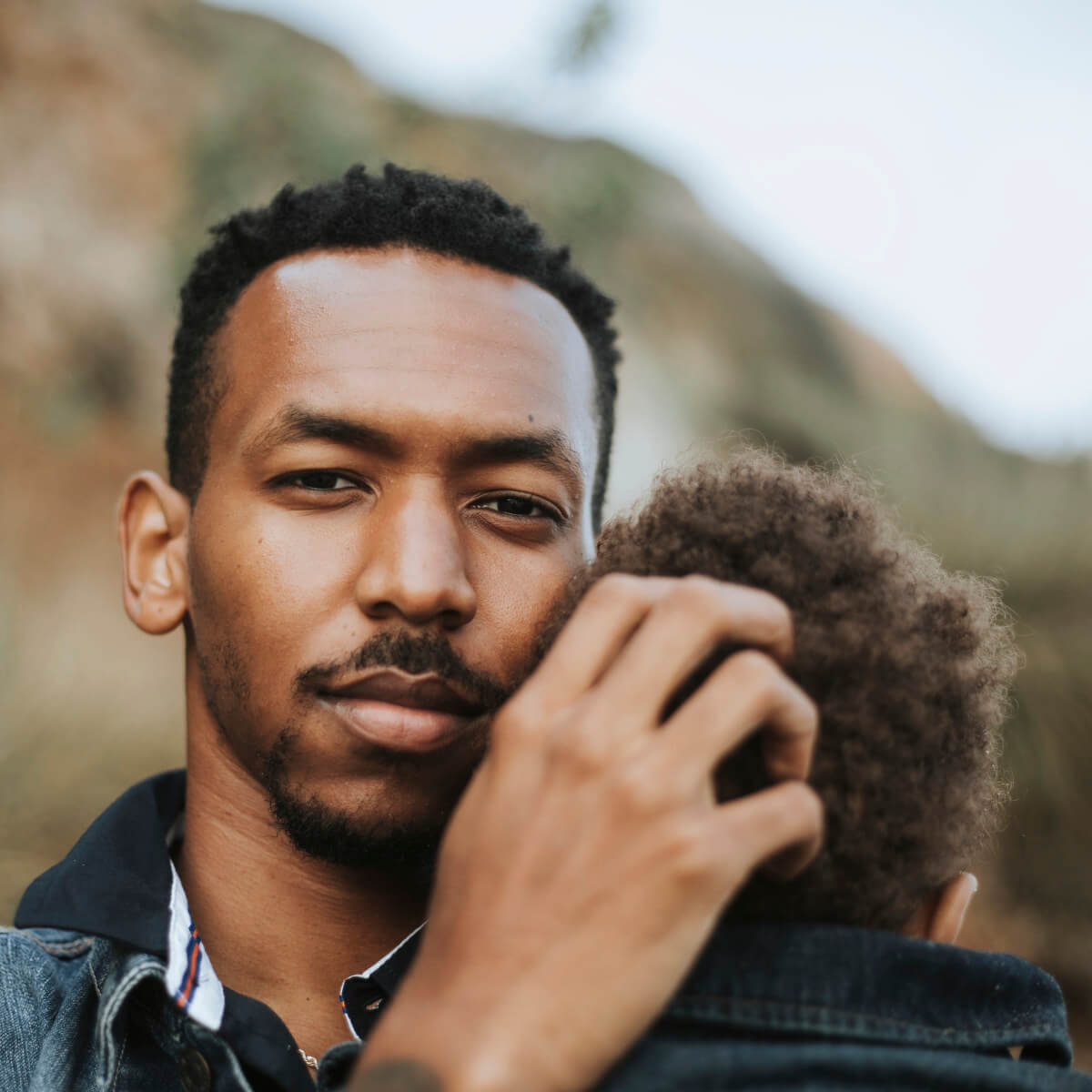Portrait of a young father holding his son